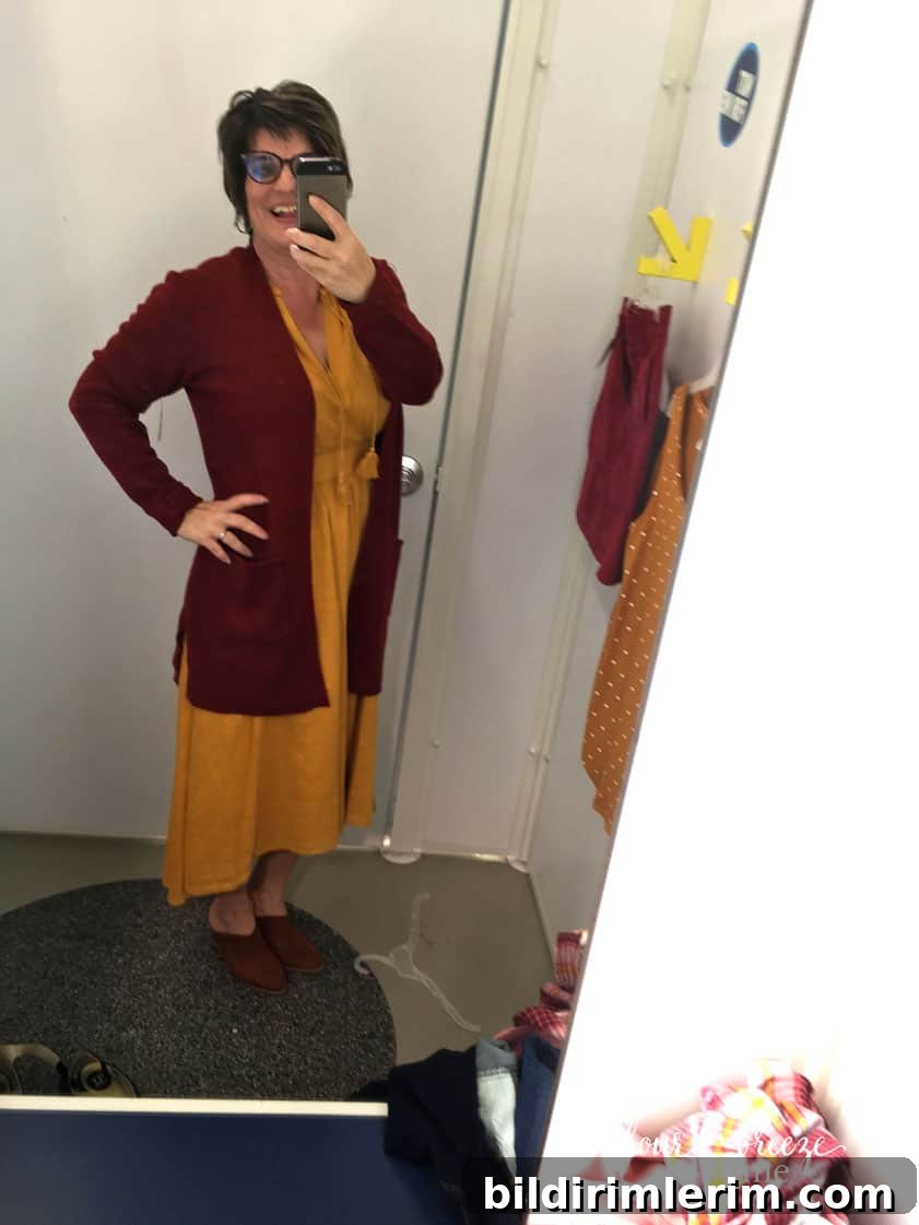 Sleeveless dress with long sweater layered for fall