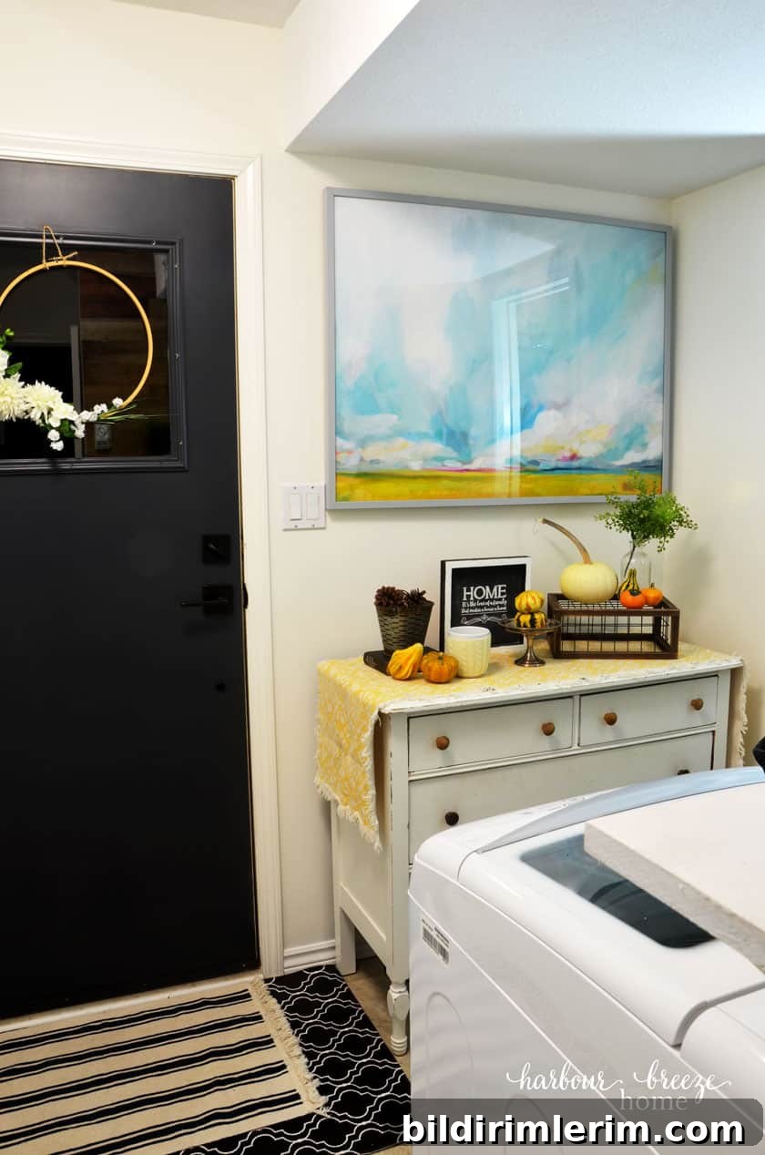Small Laundry Room Makeover Ideas on a Tight Budget 10 Back Entrance Door with White Dresser and Watercolor Art from Minted above it