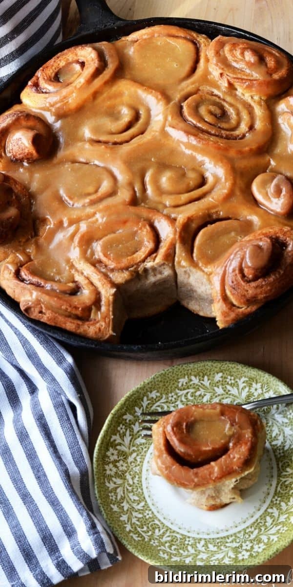 Cast Iron Skillet Cinnamon Rolls with Caramel Glaze 2 caramel cinnamon rolls in a cast iron skillet