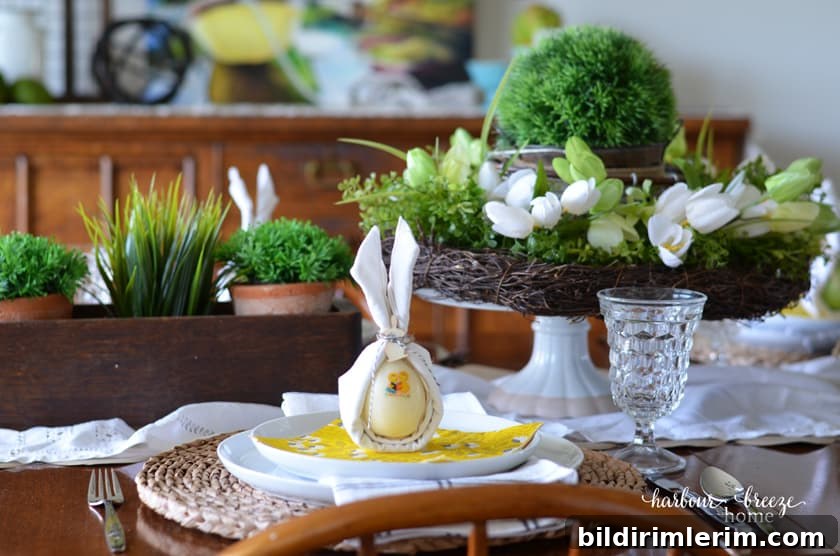 A cloth napkin with the bunny ear napkin fold sitting on top of an easter tablescape setting.