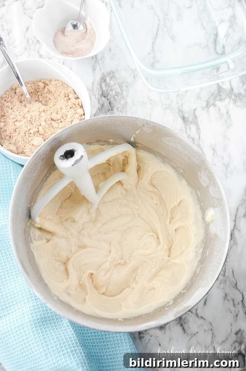 Copycat Starbucks Coffee Cake Recipe to Make at Home 3 Coffee cake batter being assembled in a pan.