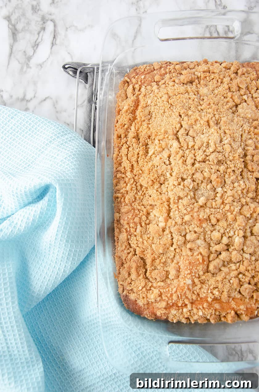Copycat Starbucks Coffee Cake Recipe to Make at Home 5 Freshly baked coffee cake cooling on a rack.