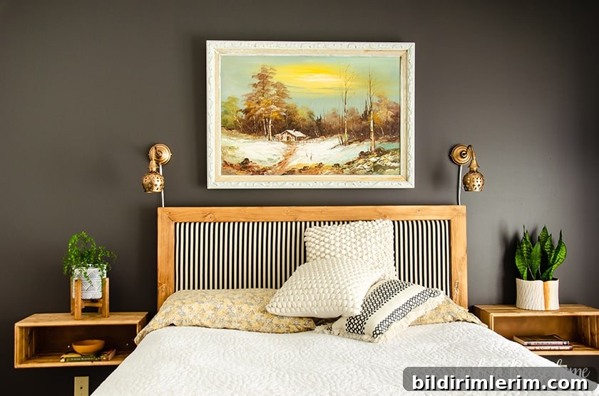 Bedroom wall painted in dark gray with bed and bedside tables