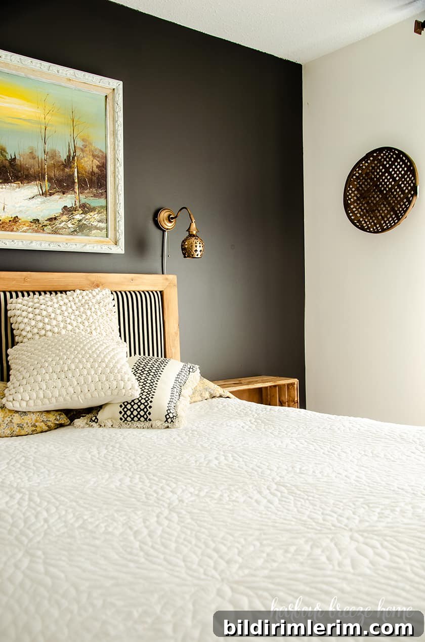 Wide view of the updated master bedroom with a dark feature wall and white surrounding walls