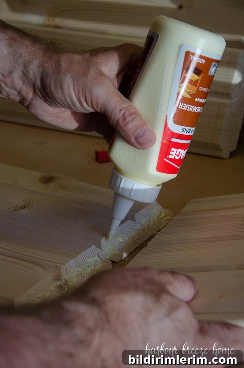 Glue being squeezed onto the edges that need to join together for DIY floating bedside tables