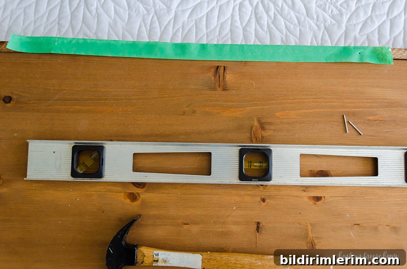 Hang a Picture on Drywall with Two Hooks: Step-by-Step Guide 4 Painter's tape laid across the top of a picture with two holes in the spot where the hangers need to be placed.