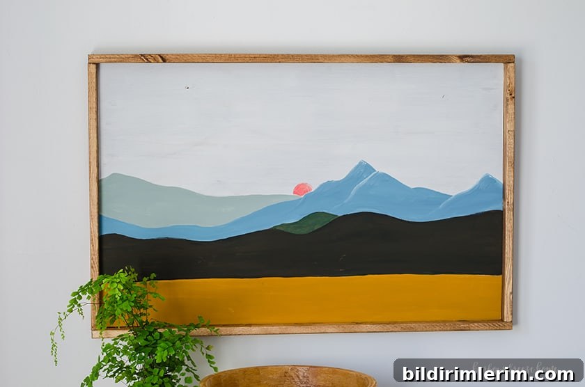 Hang a Picture on Drywall with Two Hooks: Step-by-Step Guide 9 Painting of a mountain scene in color block modern art method.