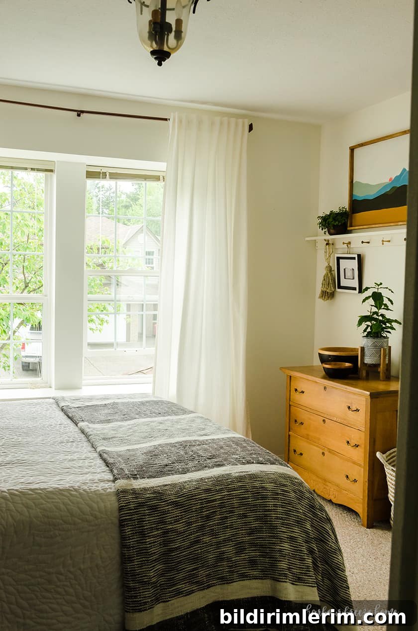 Ikea Curtains hung on copper looking rods in a bedroom