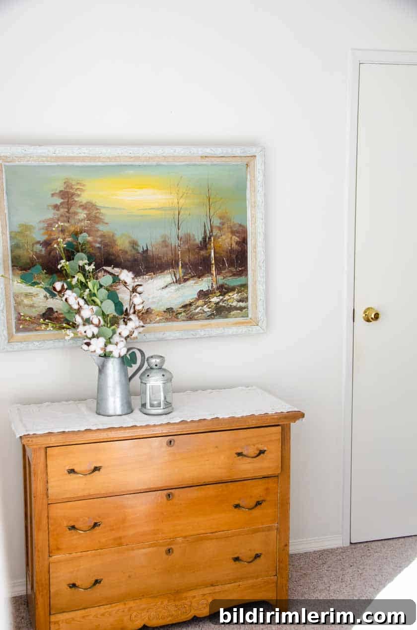 A Wood dresser with artwork above it.
