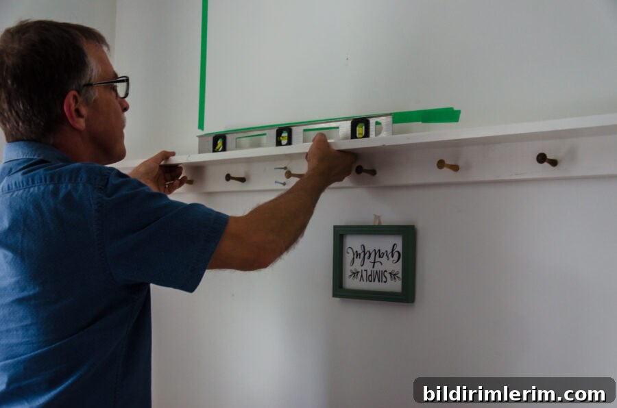 Using a level to make sure the shelf is level.