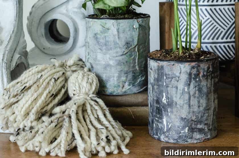 Finished DIY flower pots out of tin cans that look like cement.