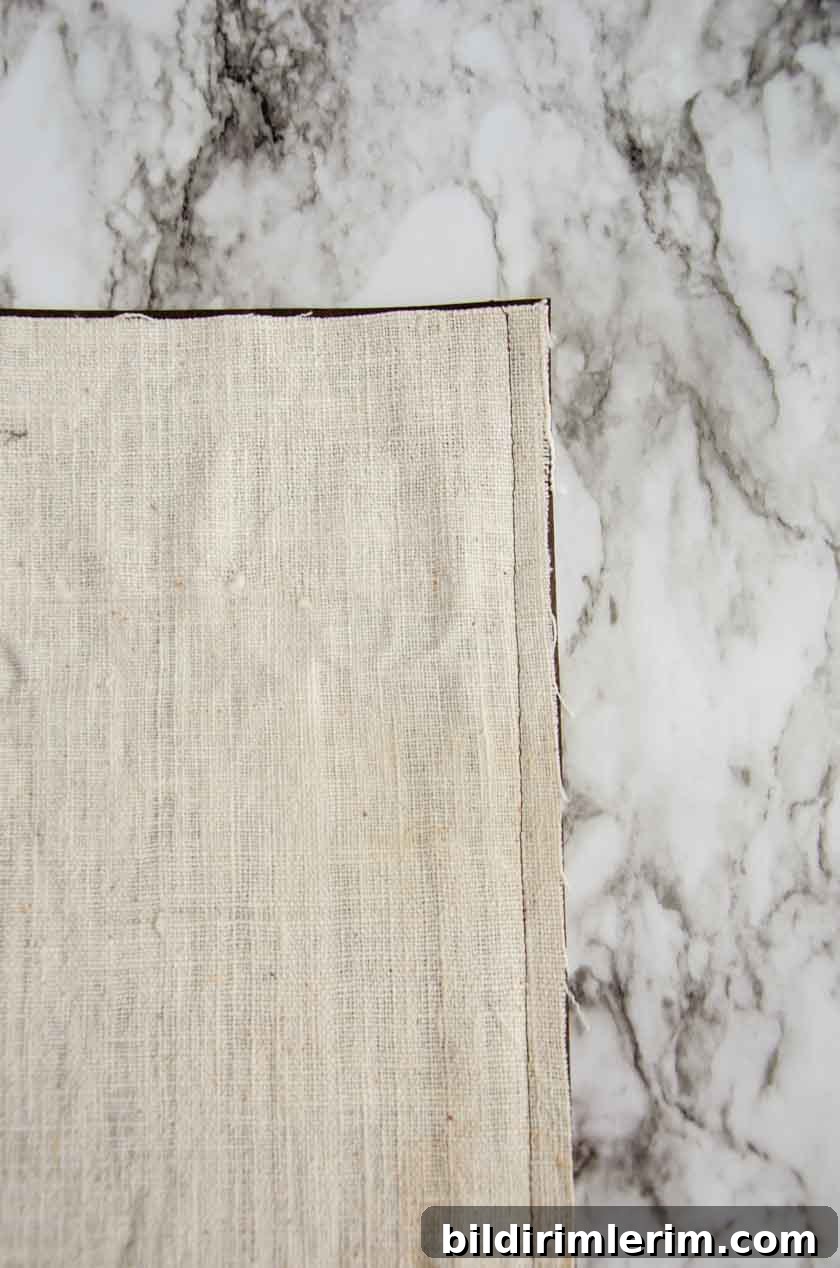 The bottom seam in a faux leather pillow cover.