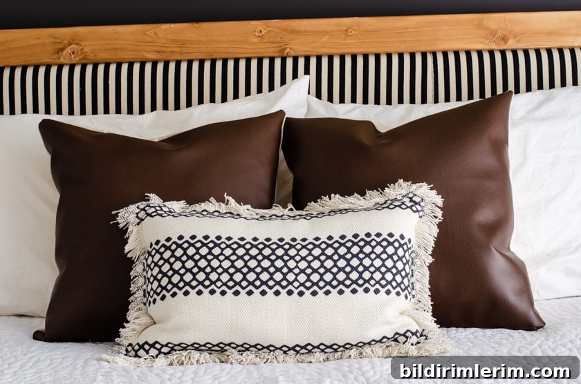 2 faux leather pillow covers on a bed