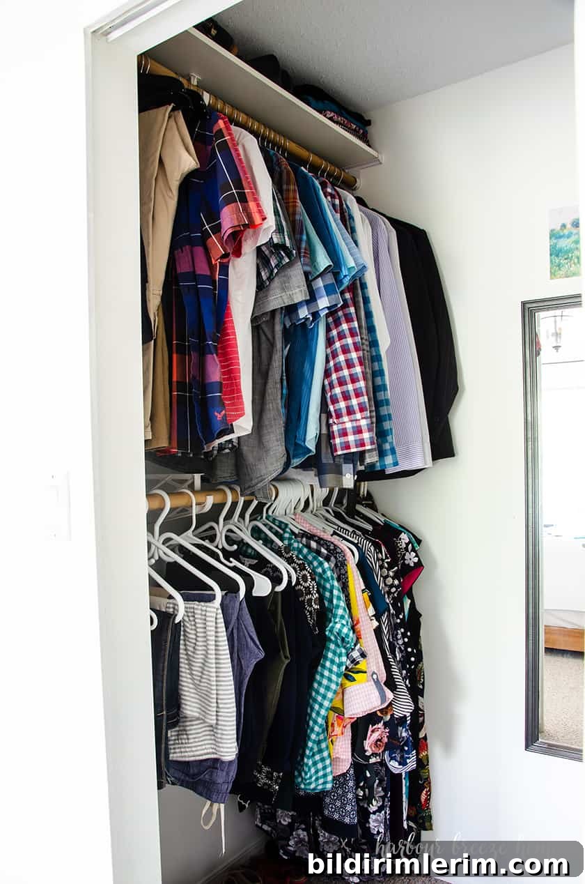 Boho Master Bedroom Makeover: Before and After Reveal 5 An organized closet with 2 hanging sections one on top of the other.