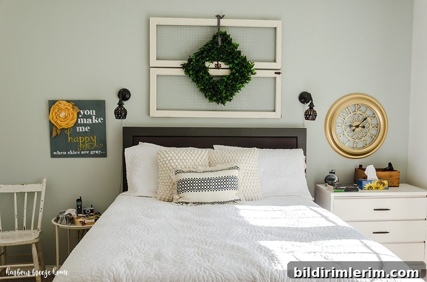 Boho Master Bedroom Makeover: Before and After Reveal 7 Bedroom with a dresser beside one side and a table and chair on the other.