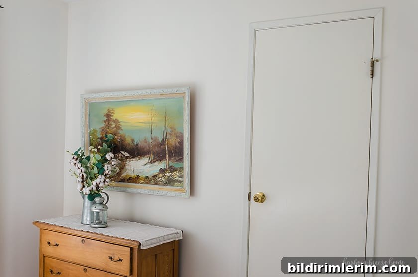 Modernize Your Bedroom with Sleek New Door Knobs 3 White interior door with thin trim around it and a brass door knob - before new bedroom door knobs