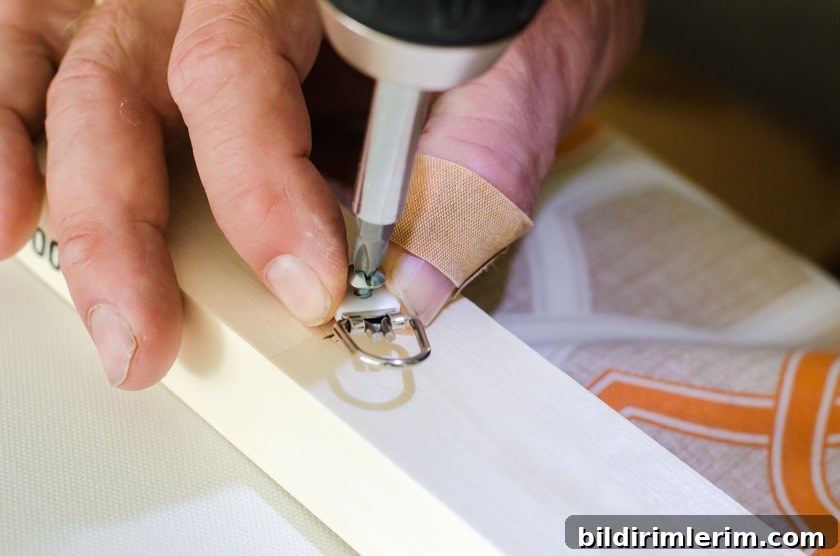 Screwing in D-ring hangers on canvas frame