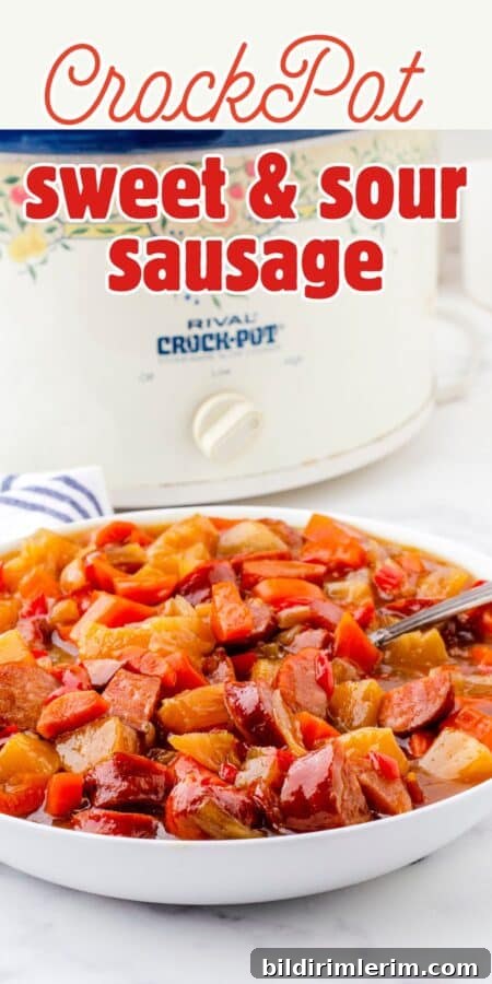 a crock pot with a big bowl of sweet and sour sausage and peppers in front of it.