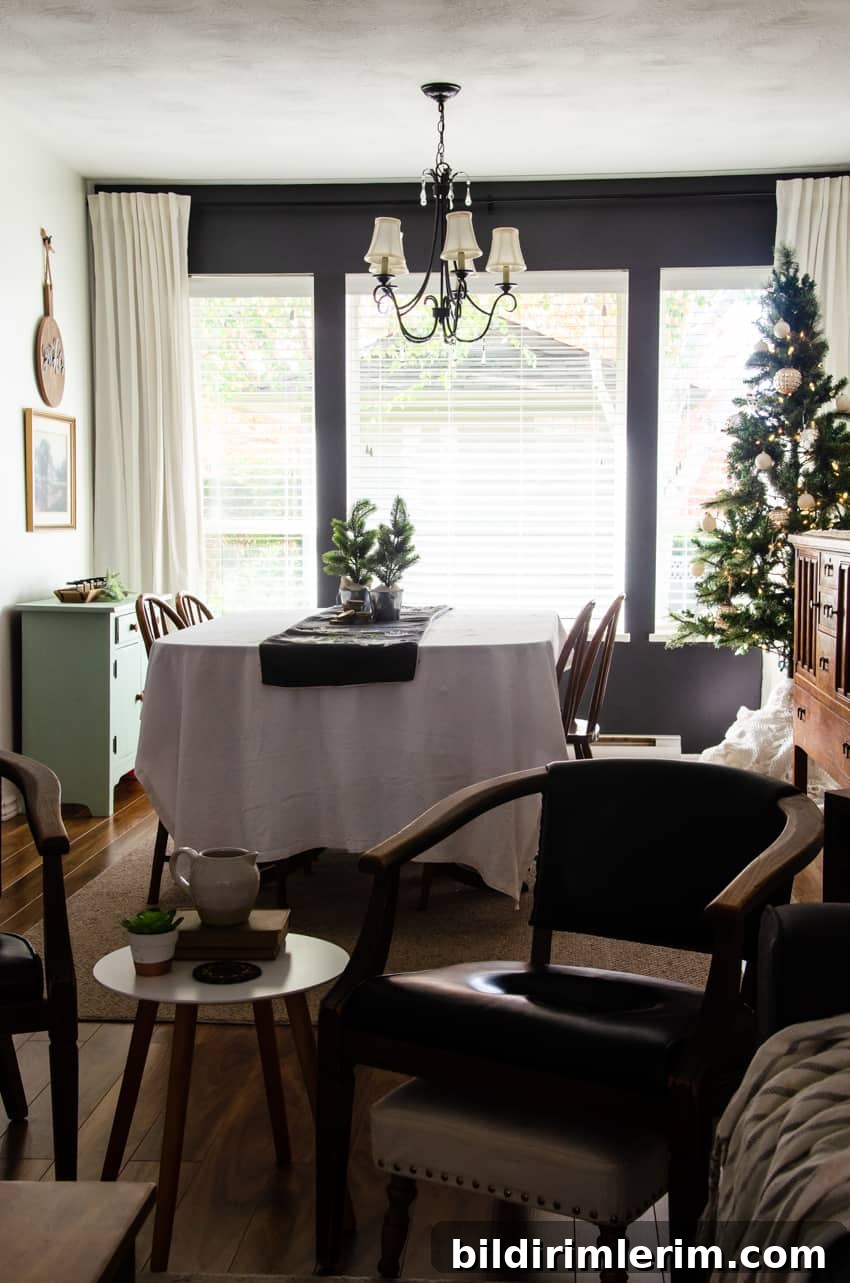 a Dining Room with a dark gray painted accent wall