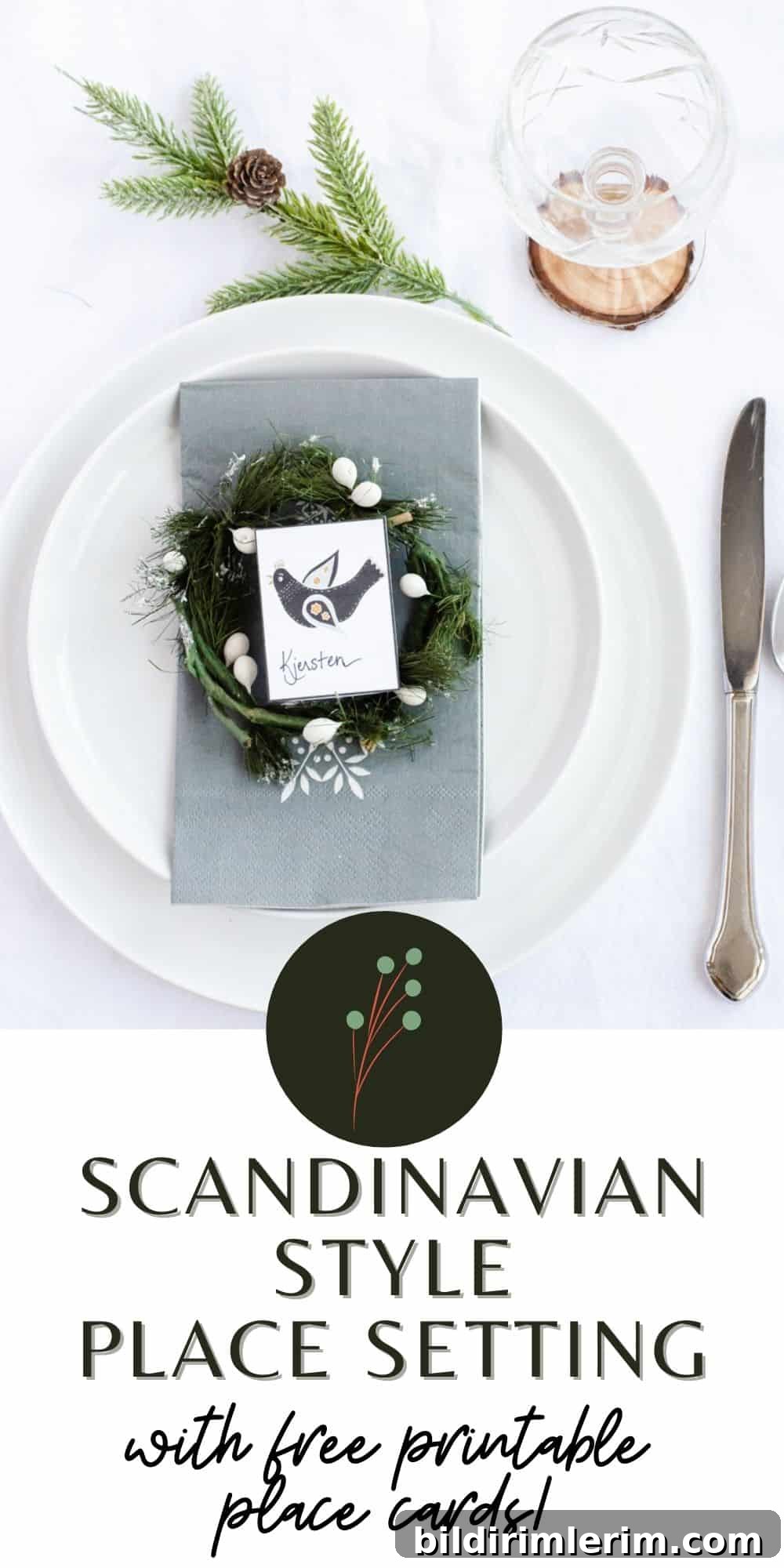 Scandinavian Christmas table with white plates and greenery