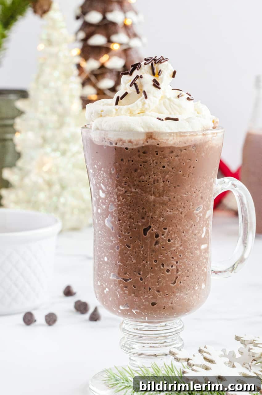 A mug of frozen hot chocolate with Christmas tree lights in the background.