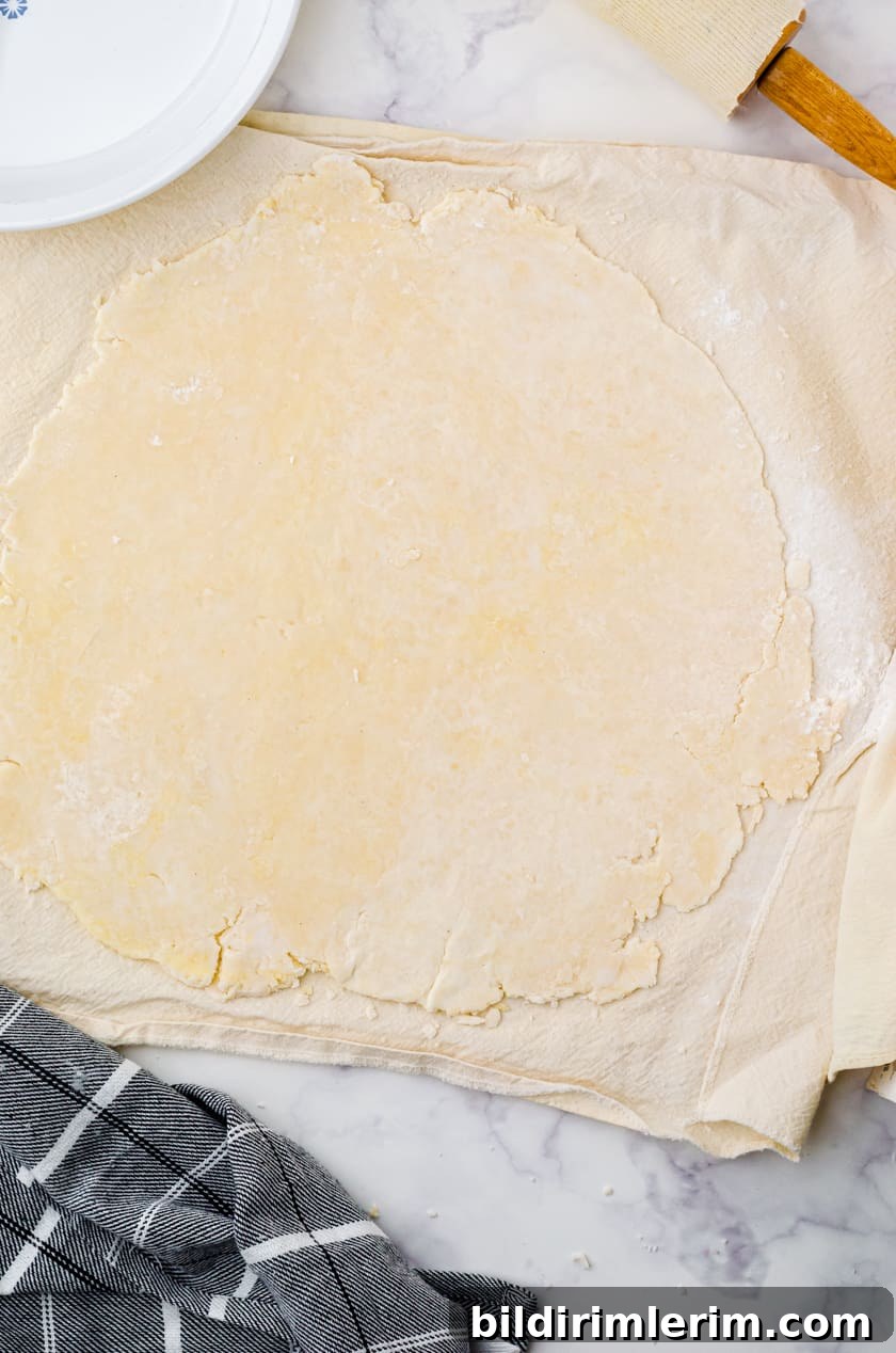 Rolling out pie crust on a pastry cloth
