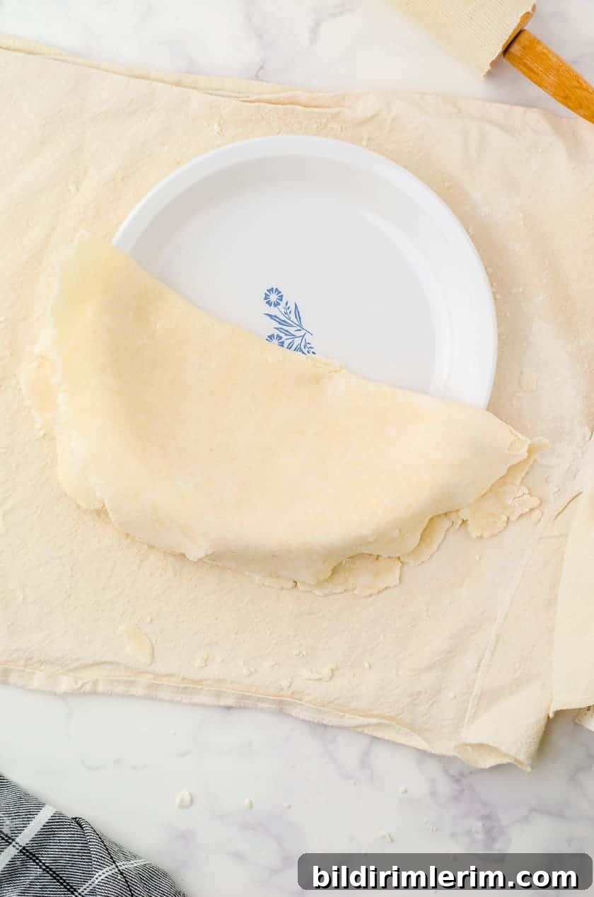 Fitting rolled pie crust into pie pan
