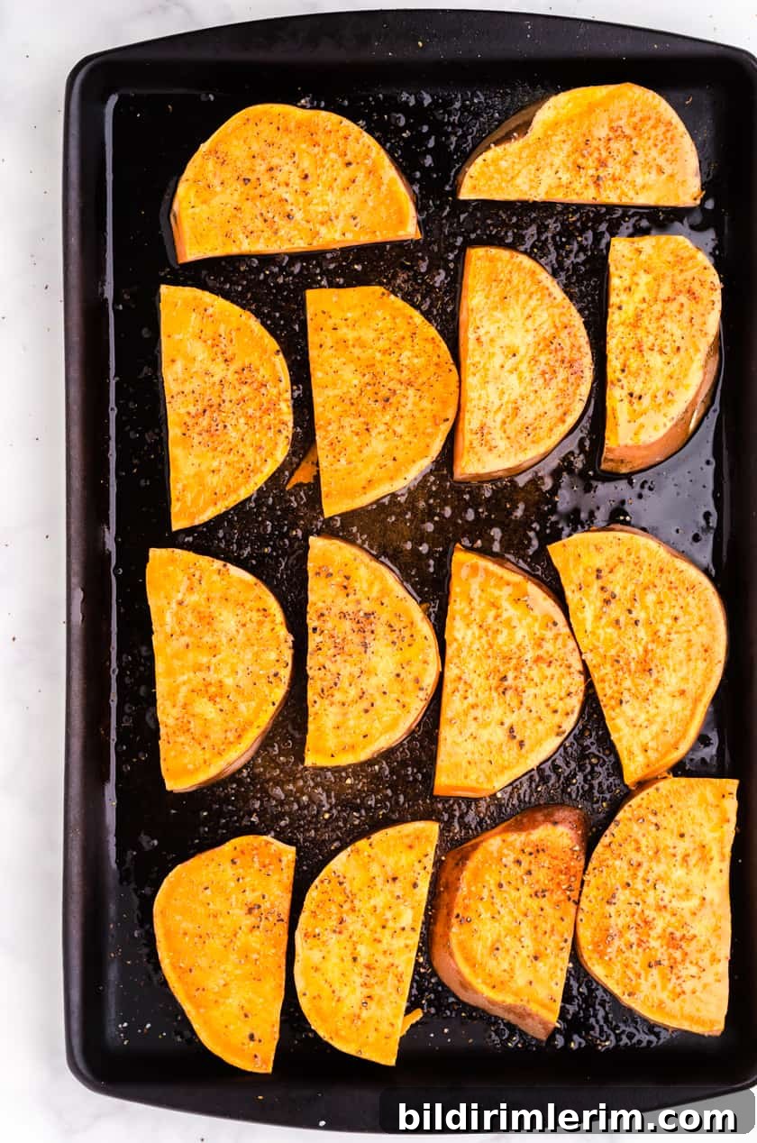 Sliced large sweet potato on baking sheet