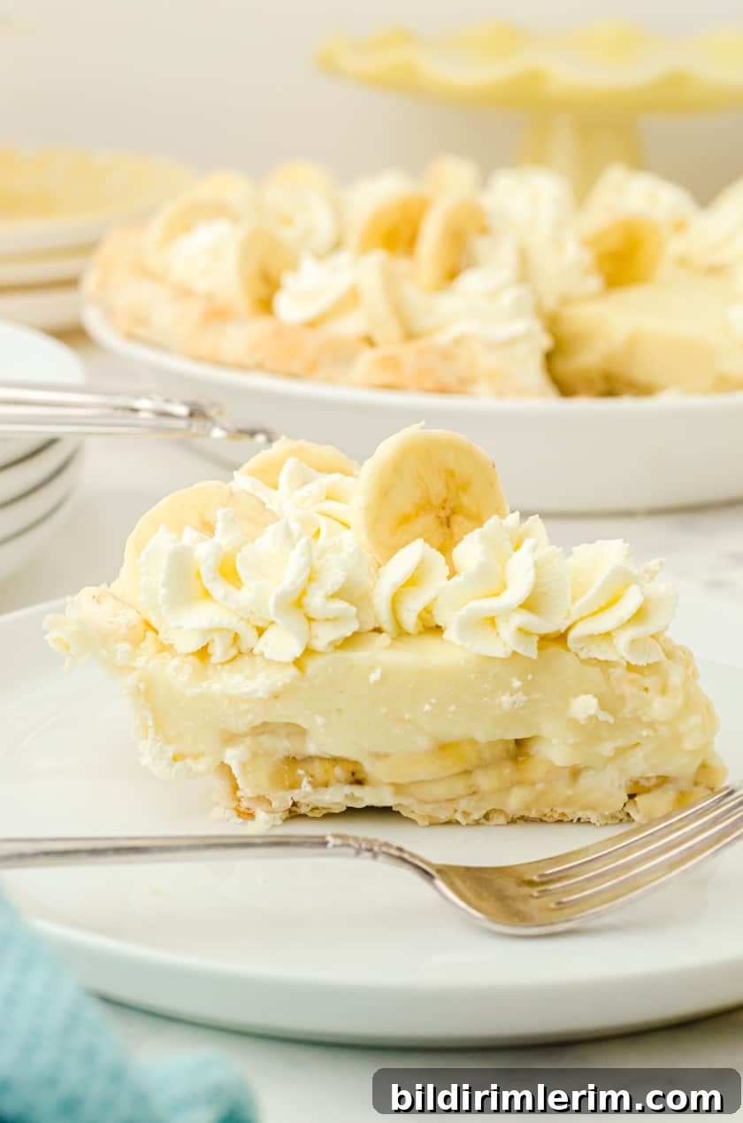 Piece of banana pudding pie on a white plate