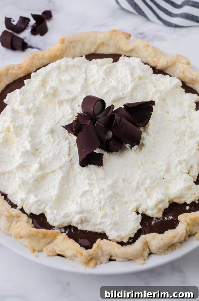 Close up of a whole chocolate cream pie.