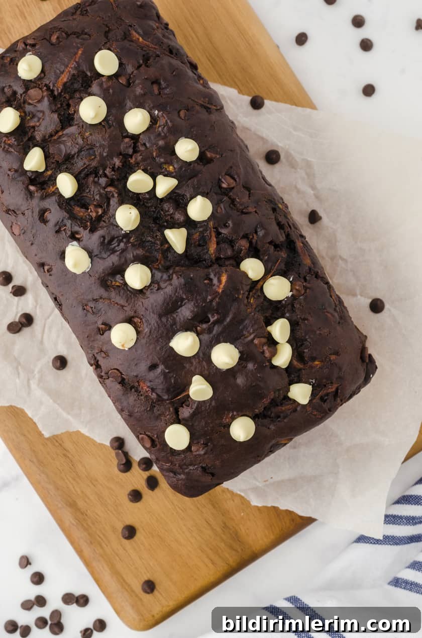 a loaf of chocolate zucchini bread on a cutting board