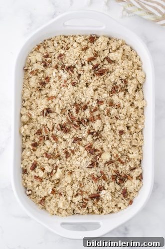 Apple crisp with apple pie filling in a 9x13 inch pan ready to be baked.