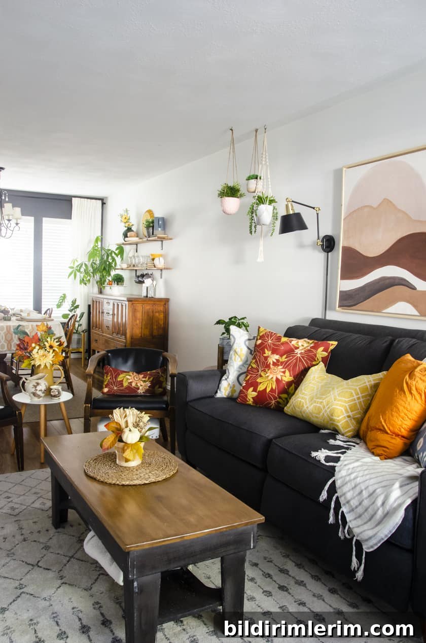 Townhouse living room decorated for Fall with sunflower yellow and floral pillows on the couch.