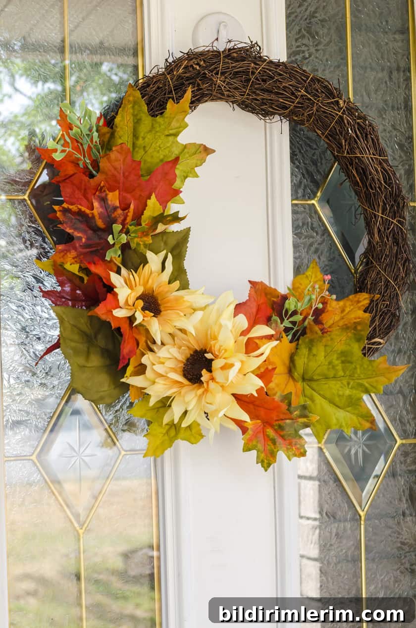 Fall wreath with fake flowers - sunflowers and fake fall leaves on a grapevine wreath base