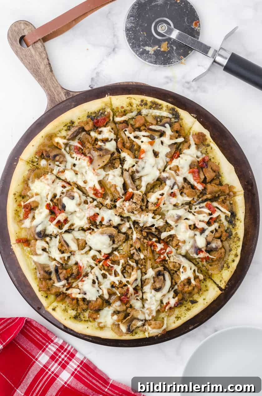 Sliced Sausage Pizza on a pizza stone.
