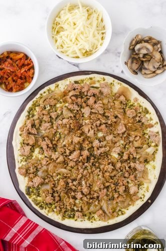 italian sausage layered on a homemade pizza