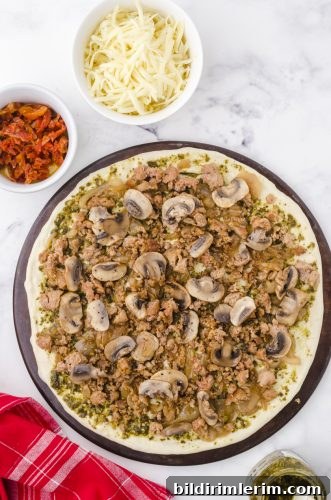 sauted mushrooms layered on pesto pizza