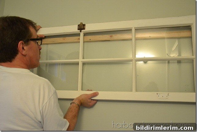 slide object down a large window being hung on a wall using a french cleat