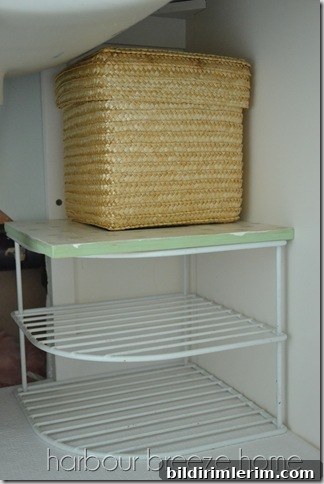 A wire corner kitchen shelf organizer in a bathroom vanity.