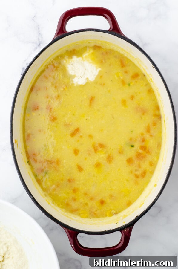 Drop dumpling dough on the top of a pot of potato soup.