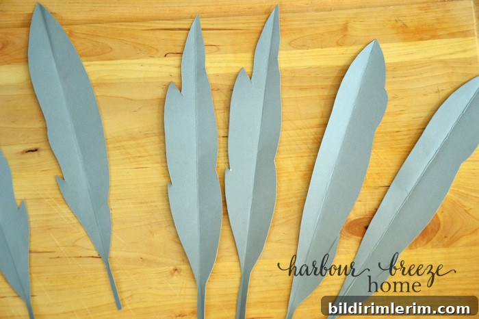 DIY Paper Feathers Tutorial: Handmade Feather Crafts 3 paper feather shapes cut out of cardstock