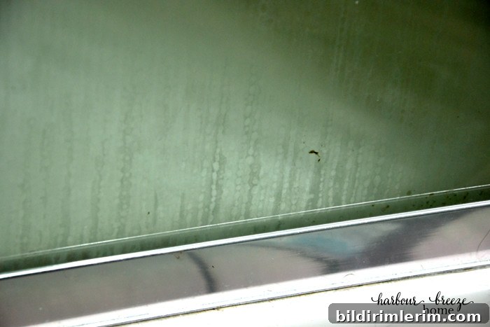 a glass shower door with scummy streaks on it