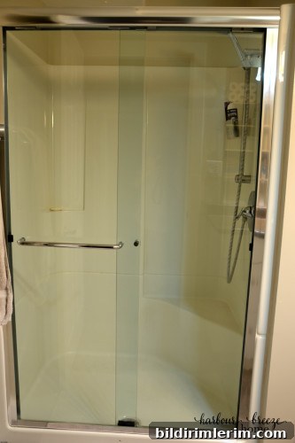 a clean shower door after it has been rinsed of the cleaner and dried off
