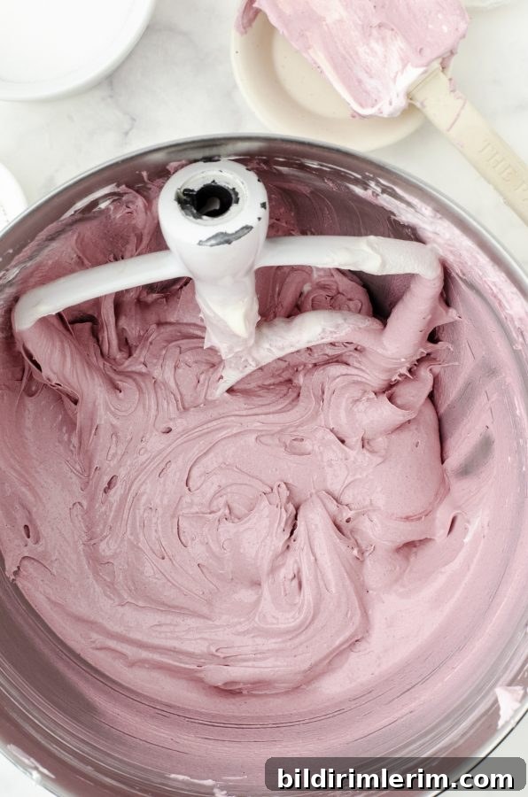 Red Velvet Cookie dough in bowl of mixer.