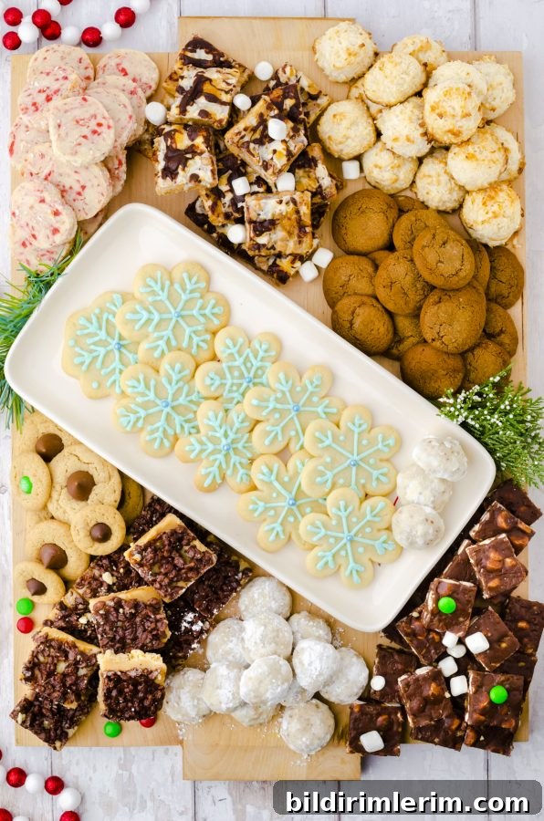 Christmas Cookie Charcuterie Board with Homemade Cookies 3 A platter of snowflake sugar cookies in the center of a large Christmas cookie charcuterie board with other cookies piled around it.