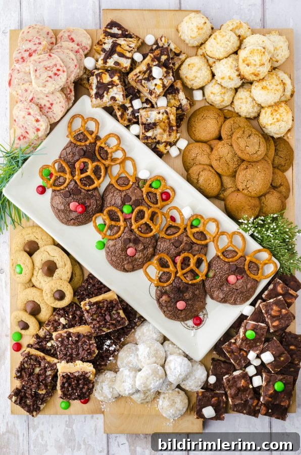 Christmas Cookie Charcuterie Board with Homemade Cookies 5 A large charcuterie board filled with dozens of different kinds of Christmas cookies, with the center plate filled with Reindeer Brownie Cookies.