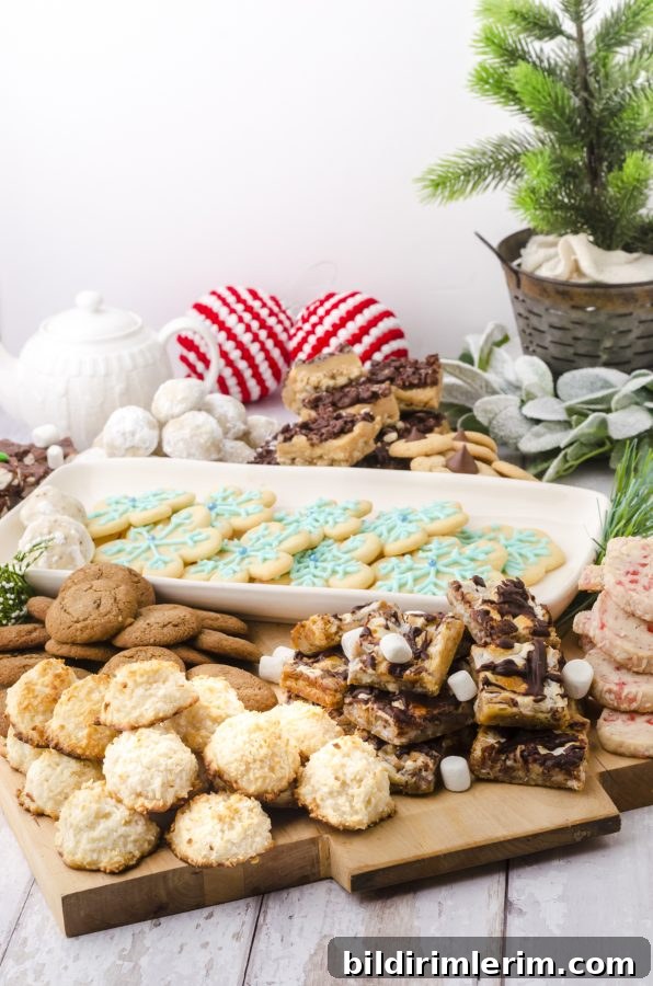 Christmas Cookie Charcuterie Board with Homemade Cookies 6 Coconut macaroons and gingersnaps piled on a flat wooden charcuterie board and sitting on a table.