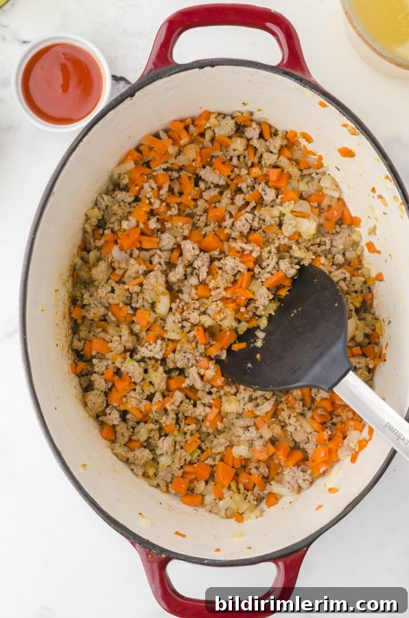 Spicy Buffalo Chicken Chili Recipe Inspired by Rachael Ray 4 Ingredients being sauted in a dutch oven as the first step for Rachael Ray buffalo chicken chili.