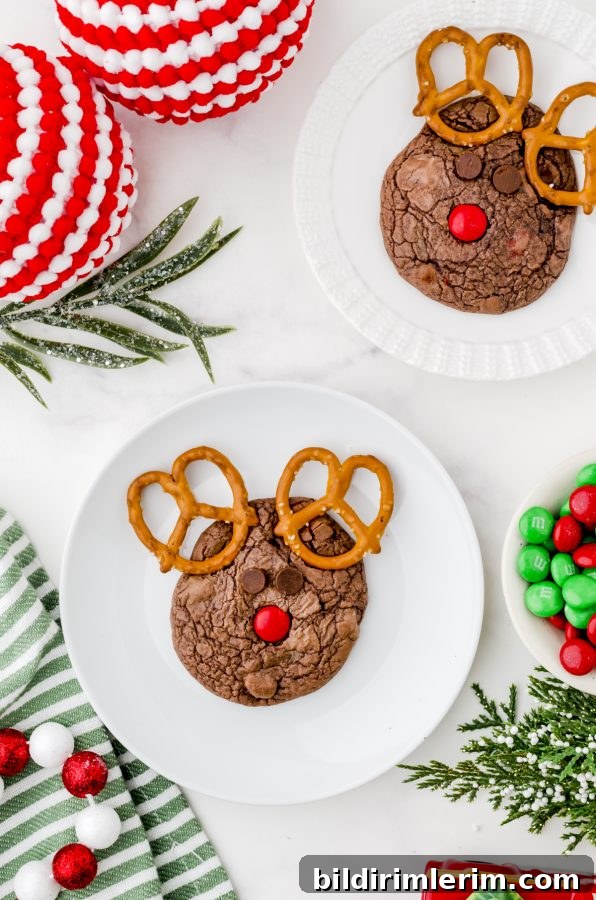 Rudolph cookies on plates with a bowl of red and green m&ms on the side