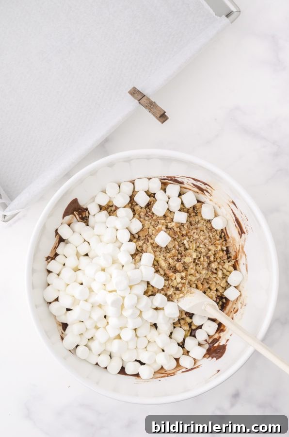 add marshmallows and nuts to fudge mixture